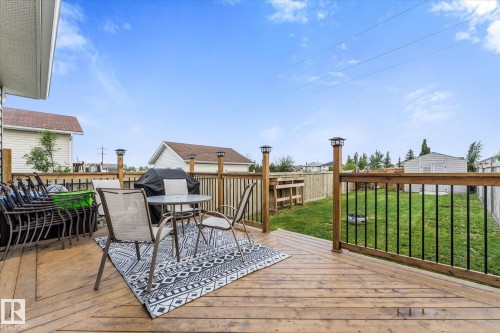 Spacious wood-finish deck with black metal balusters and post-mounted lighting - 2324 30 Avenue, Edmonton, AB 