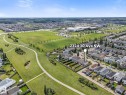 Aerial perspective showcasing a residential street with homes featuring fenced backyards - 2324 30 Avenue, Edmonton, AB 