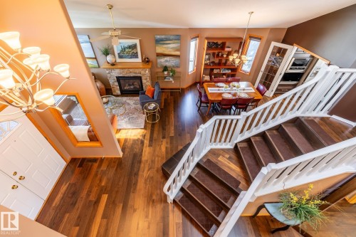 Open concept living space featuring rich wood-finish flooring throughout the main level - 315 Osland Place, Edmonton, AB 