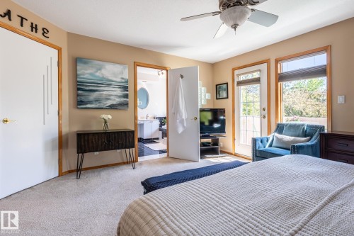 Carpeted room featuring a ceiling fan, a glass-paneled door, and a rectangular window with blinds - 315 Osland Place, Edmonton, AB 