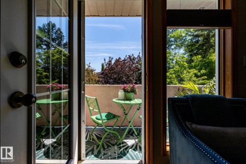 Private balcony featuring a textured concrete wall, a patterned outdoor rug, and a clear sky backdrop - 315 Osland Place, Edmonton, AB 