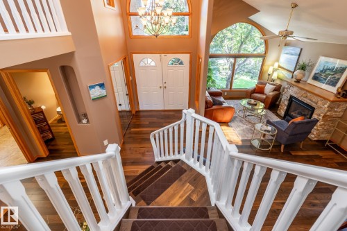 Foyer showcasing a grand double-door entry, a two-story ceiling, and wood-finish flooring - 315 Osland Place, Edmonton, AB 