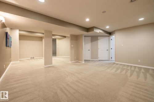 Spacious finished lower level featuring recessed lighting, plush carpet flooring, a neutral color palette, and multiple paneled doors - 315 Osland Place, Edmonton, AB 