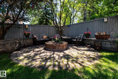 Circular paver patio featuring a central brick fire pit - 315 Osland Place, Edmonton, AB 