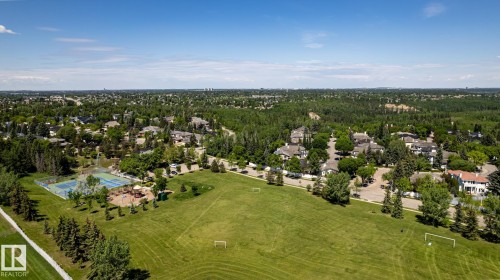 Expansive green space featuring two soccer goals, bordered by mature evergreen trees - 315 Osland Place, Edmonton, AB 