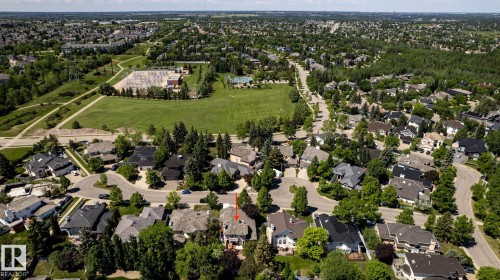 Residential neighborhood featuring mature trees, paved streets, and a large green space with recreational facilities - 315 Osland Place, Edmonton, AB 