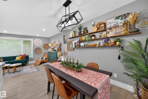 Open-concept living area with wood-finish flooring, recessed lighting, and a modern geometric chandelier - 43 Burnham Place, St. Albert, AB 