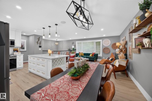 Open-concept great room with wood-finish flooring and recessed lighting - 43 Burnham Place, St. Albert, AB 