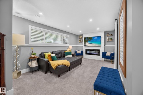 Spacious living area featuring light gray walls, plush gray carpeting, and recessed lighting - 43 Burnham Place, St. Albert, AB 