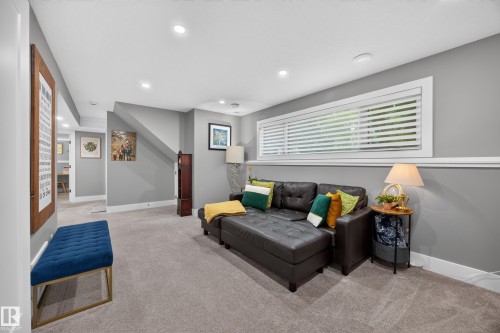 Carpeted living area featuring recessed lighting, a horizontal window with blinds, and a built-in wall trim - 43 Burnham Place, St. Albert, AB 