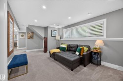 Carpeted living area featuring recessed lighting, a horizontal window with blinds, and a built-in wall trim - 