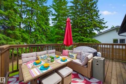 Spacious outdoor deck with natural wood railing - 