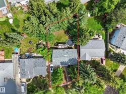 Aerial perspective showcasing a property defined by a red boundary - 