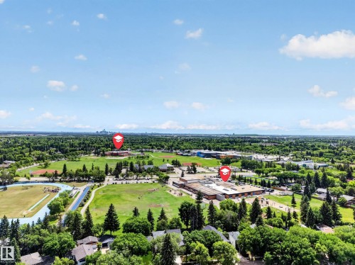 Aerial perspective showcasing expansive green spaces, mature trees, and residential rooftops - 43 Burnham Place, St. Albert, AB 