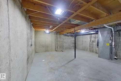 Unfinished basement featuring concrete walls and flooring, exposed wood joists, and visible utility systems - 176 Centennial Court, Edmonton, AB 