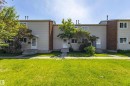 Exterior of a multi-unit property with light-colored siding and brick accents - 176 Centennial Court, Edmonton, AB 