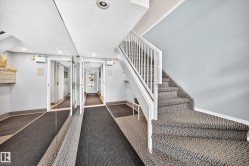 Staircase with carpeted treads and white railings - 