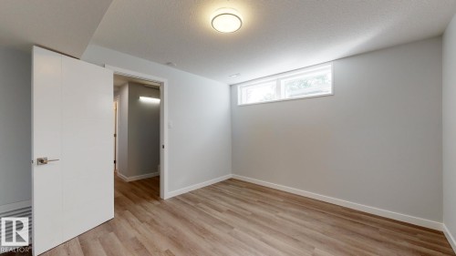 Interior room featuring wood-finish flooring and light gray painted walls - 11744 135 Street, Edmonton, AB - Indoor Photo Showing Other Room