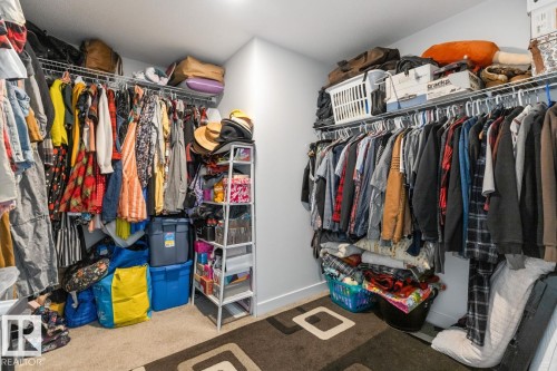 Walk-in closet featuring built-in wire shelving and hanging rods - 117 Paisley Gate Gate, Edmonton, AB 