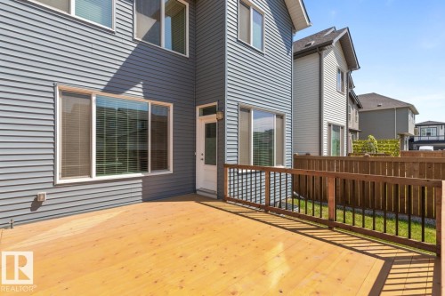 Spacious exterior deck with wood flooring and a contrasting wood and metal railing - 117 Paisley Gate Gate, Edmonton, AB 