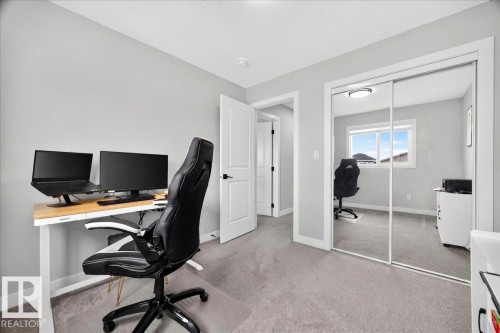 Room featuring light gray wall paint and gray carpeting - 424 Black Stone Link, Leduc, AB 