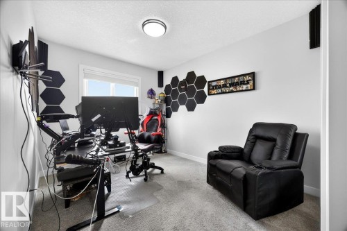 Room featuring light gray carpet flooring, white painted walls, a white ceiling, and a flush-mount ceiling light fixture - 424 Black Stone Link, Leduc, AB 