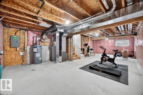 Unfinished basement with concrete flooring and exposed ceiling joists - 424 Black Stone Link, Leduc, AB 