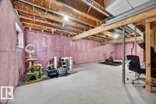 Unfinished basement with exposed wood framing, concrete flooring, and insulated walls - 424 Black Stone Link, Leduc, AB 