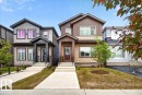 Contemporary two-story residence featuring a covered front entry with dark accent pillars - 424 Black Stone Link, Leduc, AB 