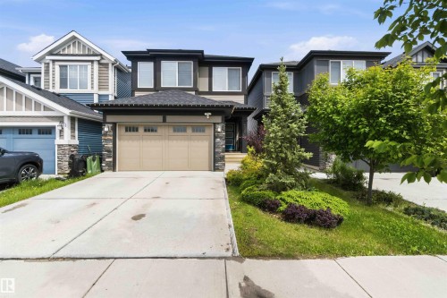 Modern two-story residence featuring a dark gray and beige exterior with stone accents - 9323 223 Street, Edmonton, AB 
