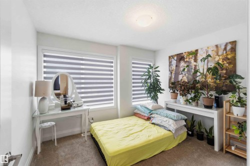 Carpeted room with white painted walls and a ceiling-mounted light fixture - 9323 223 Street, Edmonton, AB 