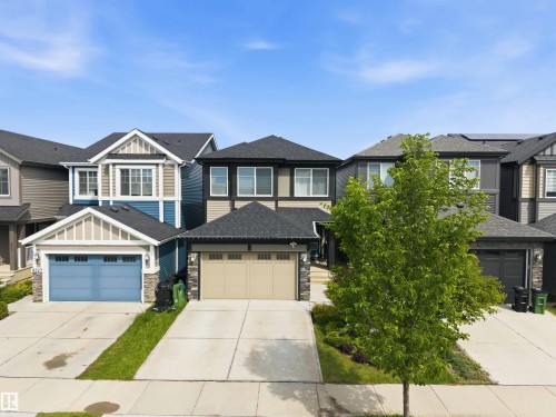 Contemporary two-story residence featuring a neutral-toned exterior with dark trim accents - 9323 223 Street, Edmonton, AB 