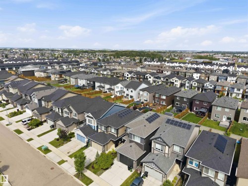 Contemporary residential community featuring a variety of detached homes, paved streets, and concrete sidewalks - 9323 223 Street, Edmonton, AB 