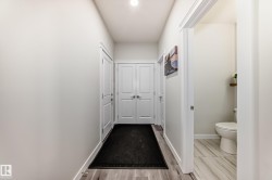 Entryway featuring wood-finish flooring and light-toned walls - 