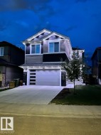 Contemporary two-story exterior featuring a grey and dark blue façade with white trim - 