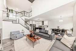 Expansive open-concept living area featuring high ceilings and wood-finish flooring - 