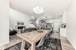 Open-concept living space featuring wood-finish flooring - 