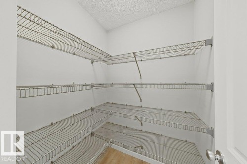 Corner pantry with extensive wire shelving, offering ample storage - 5034 Rivers Edge Way, Edmonton, AB 