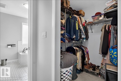 Walk-in closet with wire shelving and hanging rods - 13 Baie Madelene, Beaumont, AB 