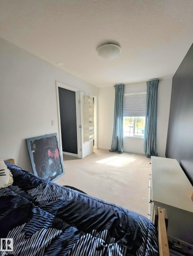 Neutral-toned carpeting extends throughout this interior space - 13 Baie Madelene, Beaumont, AB 