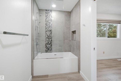 Modern bathroom featuring a combined shower and soaking tub - 3548 20 Ave, Edmonton, AB 