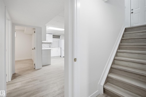 Separate Entrance- Light wood-finish flooring extending into multiple rooms - 3548 20 Ave, Edmonton, AB 
