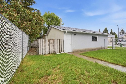 Detached accessory building with stucco exterior, a white entry door, and a single window - 3548 20 Ave, Edmonton, AB 