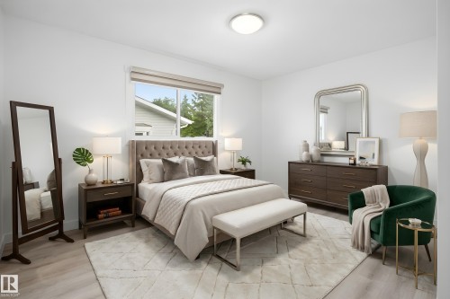 Bright bedroom featuring light wood-finish flooring and white walls - 3548 20 Ave, Edmonton, AB 