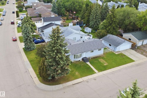Corner lot property featuring a light-colored exterior and a prominent bay window - 3548 20 Ave, Edmonton, AB 