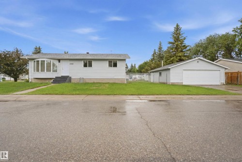 Single-story residence featuring light-colored siding, a prominent bay window, and dark exterior steps - 3548 20 Ave, Edmonton, AB 