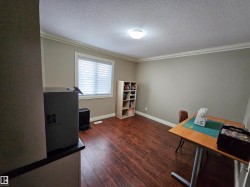 Den / Flex Room featuring wood-finish flooring and a single window with blinds - 