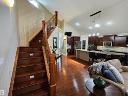 Hardwood staircase with wrought iron balusters and a wood-finish handrail - 