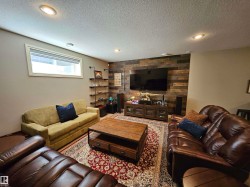 Reclaimed wood accent wall with built-in media console - 