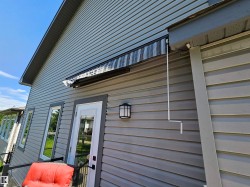 Exterior siding in a neutral tone with white trim - 
